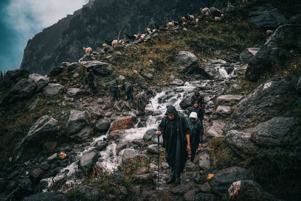 trekkers carrying things on their back while travelling to Kedarnath